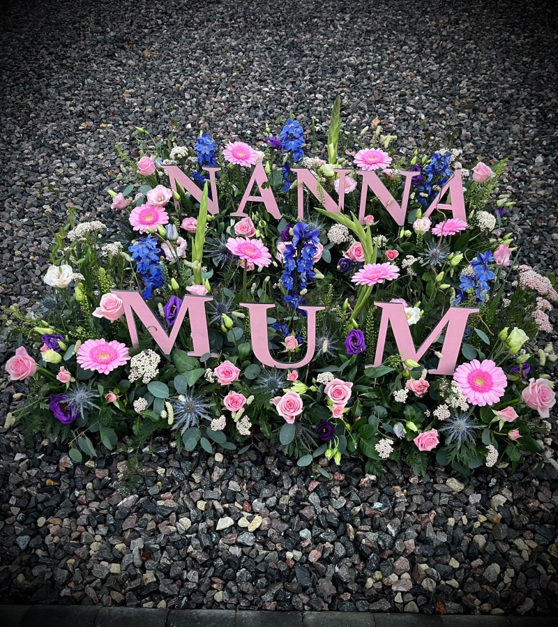 Wooden Letters in a Garden of flowers