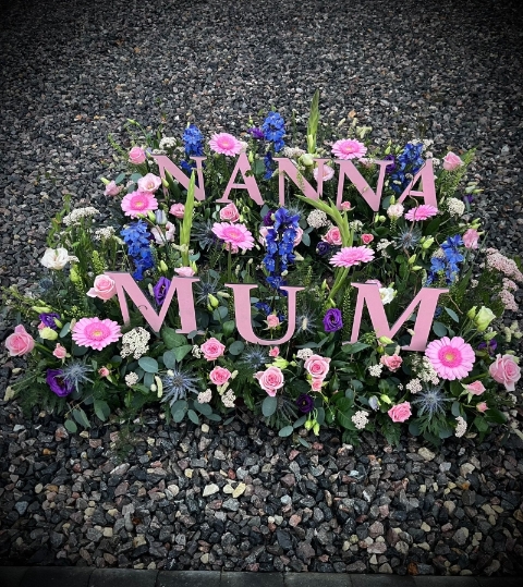 Wooden Letters in a Garden of flowers