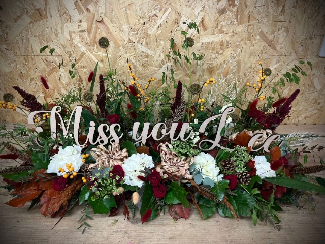 Wooden Letters in a Garden of flowers